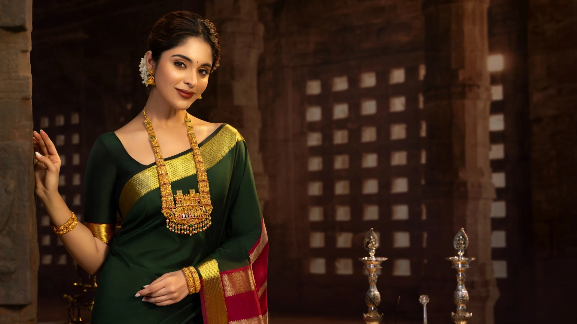 Vishnu Priya Jewellery campaign featuring a woman in a green silk saree and temple jewellery